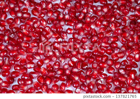 Colorful seed collage. Reflective pomegranate seeds create intricate decorative design. Vivid and glossy seeds arranged meticulously to form symmetrical mosaic pattern Colorful seed collage. Reflective pomegranate seeds create intricate decorative design. Vivid and glossy seeds arranged meticulously to form symmetrical mosaic pattern 137821765