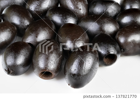 Black olives selection on ceramic tray, artisan arranging pitted olives beside spoon, culinary styling for gourmet salad and dip, briny aroma implied, premium market vibe Black olives selection on ceramic tray, artisan arranging pitted olives beside spoon, culinary styling for gourmet salad and dip, briny aroma implied, premium market vibe 137821770