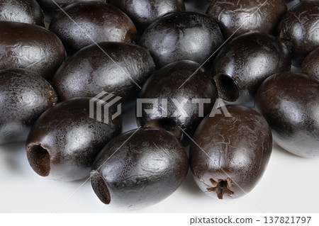 Closeup textured black olives pattern, abstract composition for design and branding, repeating glossy forms with highcontrast lighting, versatile stock backdrop 137821797