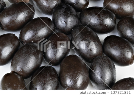 Commercial style image featuring grouped black olives on white background. Professional photography presentation of neatly arranged black olives for packaging mockup Commercial style image featuring grouped black olives on white background. Professional photography presentation of neatly arranged black olives for packaging mockup 137821851