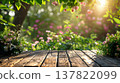 Wooden table with flowers in the garden. Selective focus. 137822099