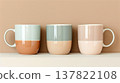 Three colorful ceramic mugs on the shelf. Vintage style. 137822108