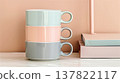 Colorful coffee mugs on the table in front of pink wall 137822117