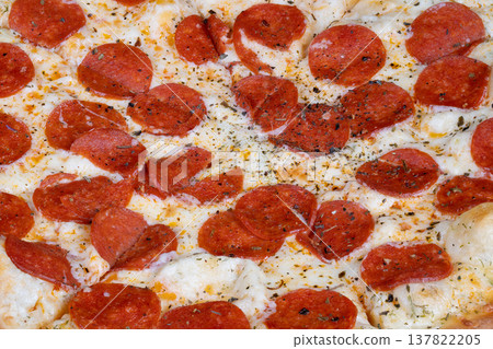 Closeup of cheesy pepperoni slice. Handheld pizza slice with salty pepperoni in social setting. Closeup of melting cheese and spicy pepperoni for group sharing event Closeup of cheesy pepperoni slice. Handheld pizza slice with salty pepperoni in social setting. Closeup of melting cheese and spicy pepperoni for group sharing event 137822205