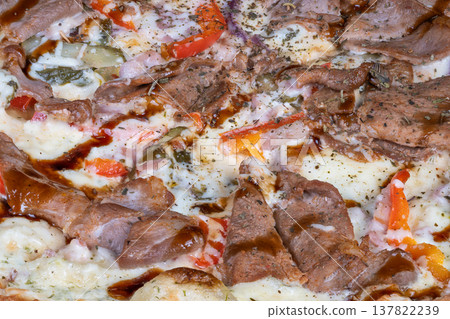 Savory pizza delight. Teriyaki drizzled cheesy beef pizza. Juicy beef slices on cheesy teriyaki crust. Flavorful pizza featuring tender beef and flavorful oregano topping 137822239