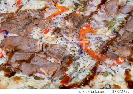 Fast service pizza advertising. Closeup of tempting teriyaki meat pizza. Appetizing promotional image showcasing melted cheese pizza with teriyaki meat and colorful peppers Fast service pizza advertising. Closeup of tempting teriyaki meat pizza. Appetizing promotional image showcasing melted cheese pizza with teriyaki meat and colorful peppers 137822252