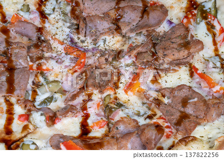 Closeup homestyle pizza with teriyaki meat, gooey mozzarella, sliced peppers and onions, sprinkled dried herbs and pepper, cozy family dinner mood and hearty ovenbaked texture Closeup homestyle pizza with teriyaki meat, gooey mozzarella, sliced peppers and onions, sprinkled dried herbs and pepper, cozy family dinner mood and hearty ovenbaked texture 137822256