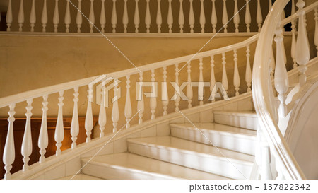 Elegant White Winding Staircase with Marble Steps, Showcasing Timeless Design and Luxurious Aesthetics in a Bright and Airy Space Elegant White Winding Staircase with Marble Steps, Showcasing Timeless Design and Luxurious Aesthetics in a Bright and Airy Space 137822342