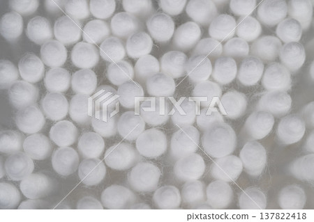 Cotton tips used for careful electronic equipment cleaning and dusting. Closeup of cotton swabs employed to meticulously clean electronic devices against mesh backdrop 137822418