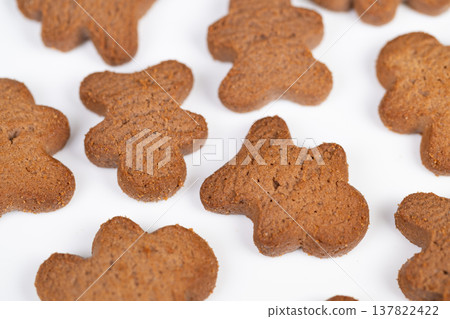 Lush cookie display. Arrangement of shamrock cookies on white background. Colorful cluster of clovershaped biscuits arranged neatly over plain white surface for marketing Lush cookie display. Arrangement of shamrock cookies on white background. Colorful cluster of clovershaped biscuits arranged neatly over plain white surface for marketing 137822422