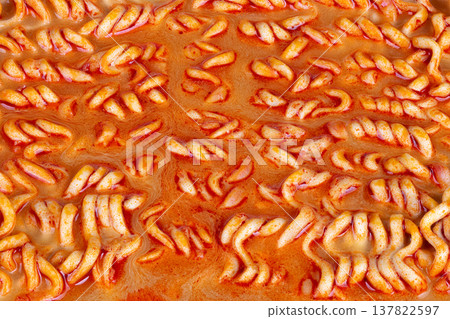 Fast tasty dinner solution. Convenient meal idea with savory broth and vibrant color. Rapidly cooked noodles immersed in seasoned orange broth ideal for busy schedules Fast tasty dinner solution. Convenient meal idea with savory broth and vibrant color. Rapidly cooked noodles immersed in seasoned orange broth ideal for busy schedules 137822597