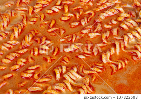 Spicy noodle imagery. Detailed view showcasing vibrant broth and heated ramen noodles. Closeup perspective highlighting vivid broth and intensely spicy noodles within Spicy noodle imagery. Detailed view showcasing vibrant broth and heated ramen noodles. Closeup perspective highlighting vivid broth and intensely spicy noodles within 137822598