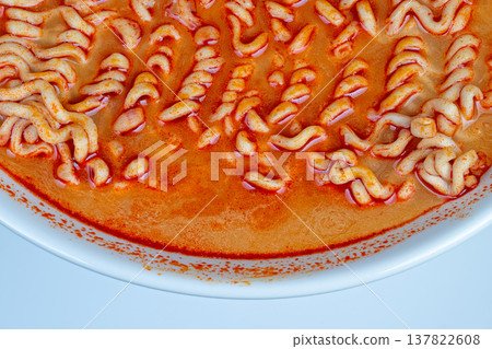 Overhead bowl rim showing noodle edges and orange broth, clean white plate contrast, fine paprika dusting along lip, editorial composition for recipe cards or food catalog Overhead bowl rim showing noodle edges and orange broth, clean white plate contrast, fine paprika dusting along lip, editorial composition for recipe cards or food catalog 137822608