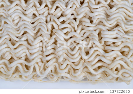Factory dry instant noodles sample focusing on uniformity and strand formation, neutral lighting emphasizes production quality, texture irregularities and raw flour traces visible 137822630