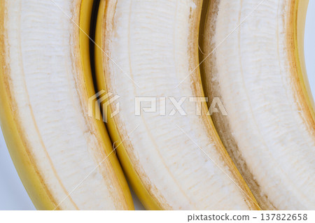 Ripe peeled bananas presented as healthy snack on white backdrop, bright lighting and crisp edges emphasize natural sweetness, ideal for nutrition, diet, and fitness marketing 137822658