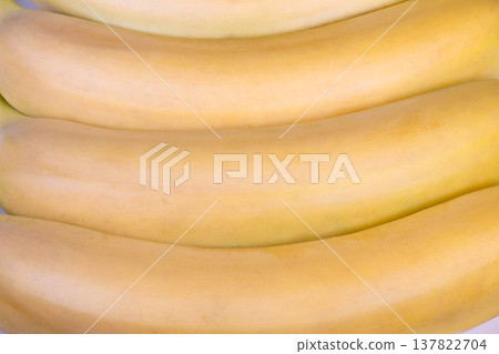Highquality image showcasing curved banana bunch on white background. Professional food photograph capturing smooth yellow peels and natural textures of bananas Highquality image showcasing curved banana bunch on white background. Professional food photograph capturing smooth yellow peels and natural textures of bananas 137822704