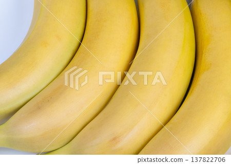 Organic banana display. Exhibition of naturally sourced ripe bananas at market. Market exhibit emphasizing environmentally friendly and ethically harvested organic bananas Organic banana display. Exhibition of naturally sourced ripe bananas at market. Market exhibit emphasizing environmentally friendly and ethically harvested organic bananas 137822706