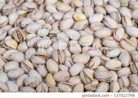 Compact display of shell surfaces. Closeup of pistachio shells with kernels. Intimate perspective of pistachio shells showcasing uneven surfaces and colors for design use Compact display of shell surfaces. Closeup of pistachio shells with kernels. Intimate perspective of pistachio shells showcasing uneven surfaces and colors for design use 137822766