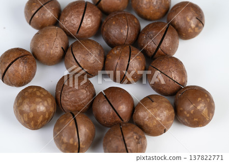 Contemporary lifestyle food arrangement. Clean design showcasing modern snack presentation. Minimalist flat design with studio lighting highlighting trendy macadamia snack mood 137822771