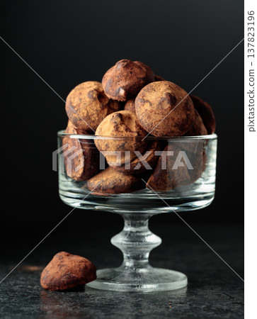 Chocolate truffles sprinkled with cocoa powder. Chocolate truffles sprinkled with cocoa powder. 137823196