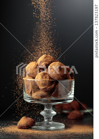 Chocolate truffles sprinkled with cocoa powder. 137823197