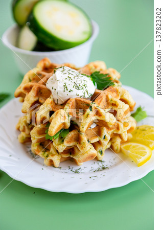 healthy zucchini waffles with sour cream and fresh parsley garnish healthy zucchini waffles with sour cream and fresh parsley garnish 137823202