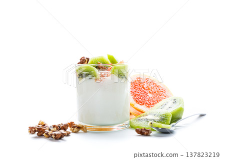 Organic yogurt dessert with kiwi, grapefruit, and walnuts on a white background Organic yogurt dessert with kiwi, grapefruit, and walnuts on a white background 137823219