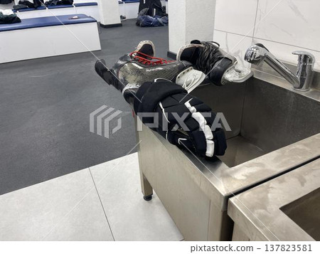 glove and skates in the locker room glove and skates in the locker room 137823581