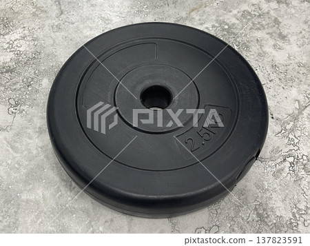 barbell weight isolated on gray floor 137823591