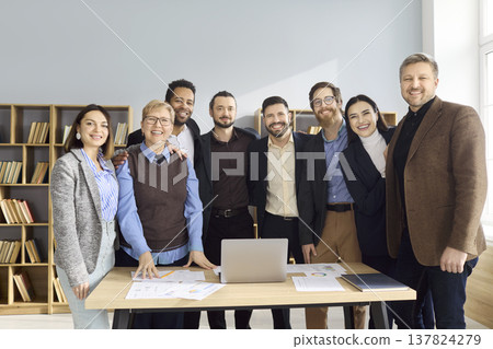 Happy diverse business team portrait standing together in bright modern office Happy diverse business team portrait standing together in bright modern office 137824279