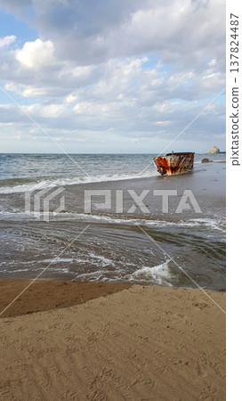 A captivating view of an old boat resting on the sandy beach of the Kuril Islands. A captivating view of an old boat resting on the sandy beach of the Kuril Islands. 137824487