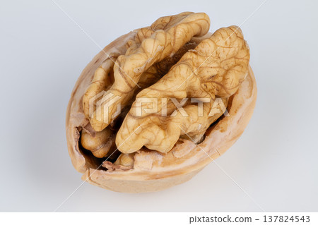 Closeup of nutritious walnut surface. Highquality image of walnut with depth and detail. Photograph highlighting nutritional surface and intricate crevices of walnut Closeup of nutritious walnut surface. Highquality image of walnut with depth and detail. Photograph highlighting nutritional surface and intricate crevices of walnut 137824543