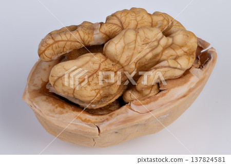 Simple nut display. Minimalist photograph of single walnut on clear background. Elegant flatlay featuring lone walnut kernel amidst minimalist environment with negative space Simple nut display. Minimalist photograph of single walnut on clear background. Elegant flatlay featuring lone walnut kernel amidst minimalist environment with negative space 137824581