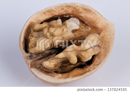 Walnut half healthy snack closeup, solitary kernel evokes wholesome snacking and natural protein source, warm tones and simple composition for nutrition content Walnut half healthy snack closeup, solitary kernel evokes wholesome snacking and natural protein source, warm tones and simple composition for nutrition content 137824585