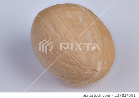 Simple walnut art. Elegant still life depiction. Calm natural scene with walnut on plain background. Serene composition of inshell walnut with minimalist aesthetic 137824591
