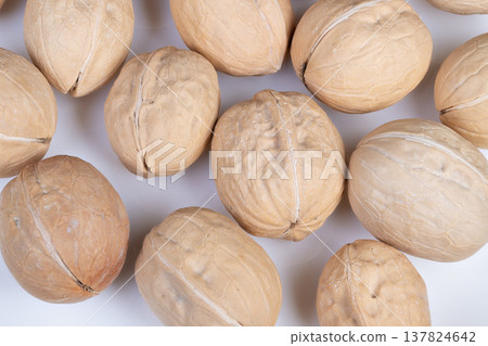 Walnuts display setup. Arrangement of shelled walnuts for catalog presentation. Display configuration of uniformly sized walnuts within shells for digital catalog imagery Walnuts display setup. Arrangement of shelled walnuts for catalog presentation. Display configuration of uniformly sized walnuts within shells for digital catalog imagery 137824642