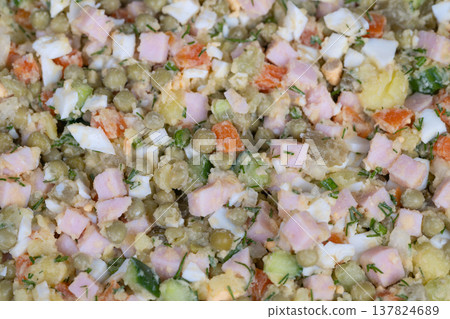 Ingredient mosaic chopped salad showing ham, potato cubes, sliced cucumber, peas and chopped egg crisp colors, kitchen counter context, focus on texture and raw components 137824689