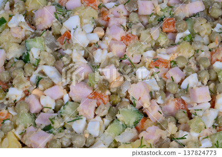 Upscale buffet presentation featuring garnished ham salad. Sophisticated catering display showcasing meticulously arranged ham and potato salad with fresh herbs Upscale buffet presentation featuring garnished ham salad. Sophisticated catering display showcasing meticulously arranged ham and potato salad with fresh herbs 137824773