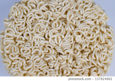 Round instant noodles cake centered on white studio background, topdown product composition, soft even lighting, ideal for packaging, ecommerce and minimal food branding 137824802