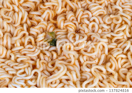 Repetitive noodle strands forming intricate edible patterns for art. Detailed closeup revealing curly noodle designs and subtle seasoning for artistic backgrounds and projects 137824816