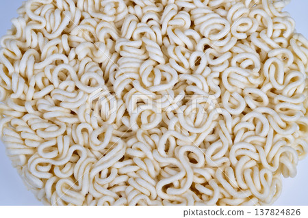 Abstract instant noodles pattern fills frame with looping curls and rhythmic repetition, sculptural texture and pale tones create decorative food art and design motif Abstract instant noodles pattern fills frame with looping curls and rhythmic repetition, sculptural texture and pale tones create decorative food art and design motif 137824826
