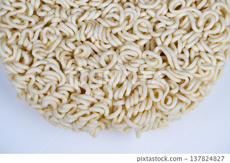 Large batch production demonstrates uniformity and dry texture quality. Inspection of instant noodles shows standardized shape and compressed dry texture quality indicators 137824827