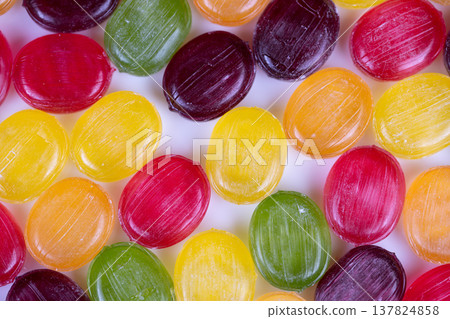 Multicolored confectionery pattern provides smooth visual backdrop. Vibrant display of repetitive candies forms engaging and smooth visual setting in background Multicolored confectionery pattern provides smooth visual backdrop. Vibrant display of repetitive candies forms engaging and smooth visual setting in background 137824858