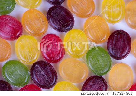 Colorful sweet display. Brightly colored candies arranged in nostalgic setting. Collection of vividly hued candies presented amidst nostalgic and warm retail environment Colorful sweet display. Brightly colored candies arranged in nostalgic setting. Collection of vividly hued candies presented amidst nostalgic and warm retail environment 137824865
