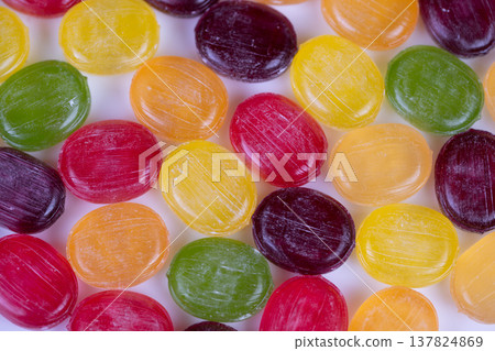 Colorful candy samples. Varied shiny sweet treats. Assorted glossy candies for visual presentation. Multicolored confectionery pieces showcased for catalog and promotional visuals 137824869