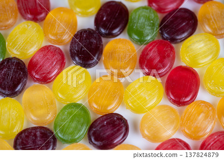 Bright candies enhance party presentations. Vivid confections add flair to dessert displays. Multicolored sweets serve as decorative elements for desserts and events 137824879