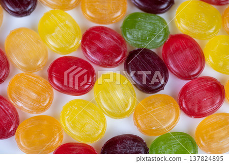 Neat multicolored hard candies aligned for retail display or packaging mockup, clean white backdrop, bright palette and commercial food styling for confection brand imagery Neat multicolored hard candies aligned for retail display or packaging mockup, clean white backdrop, bright palette and commercial food styling for confection brand imagery 137824895