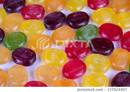 Bright and cheerful snack made from natural fruit flavors. Vivid assortment of fruitinspired candies featuring tangy citrus and berry flavors for seasonal cooking Bright and cheerful snack made from natural fruit flavors. Vivid assortment of fruitinspired candies featuring tangy citrus and berry flavors for seasonal cooking 137824907