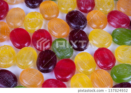 Shop display multicolored candies in jars and bowls on white shelf, confectionery showcase evokes nostalgic retail charm, variety of flavors and vivid tones attract customers Shop display multicolored candies in jars and bowls on white shelf, confectionery showcase evokes nostalgic retail charm, variety of flavors and vivid tones attract customers 137824932