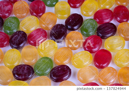 Glossy surfaces with sugary dust create vintage appeal. Vivid candy designs with shiny finishes and sugar coatings evoke warm childhood memories and retro charm Glossy surfaces with sugary dust create vintage appeal. Vivid candy designs with shiny finishes and sugar coatings evoke warm childhood memories and retro charm 137824944